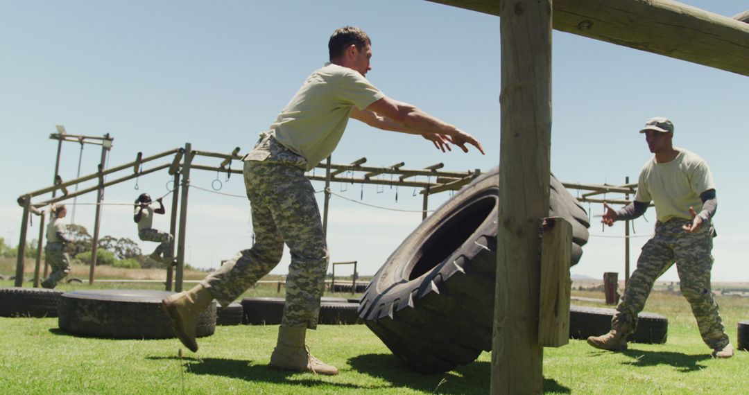 A fit soldier trains by flipping a tire outdoors at a sunny boot camp. - Free Images, Stock Photos and Pictures on Pikwizard.com