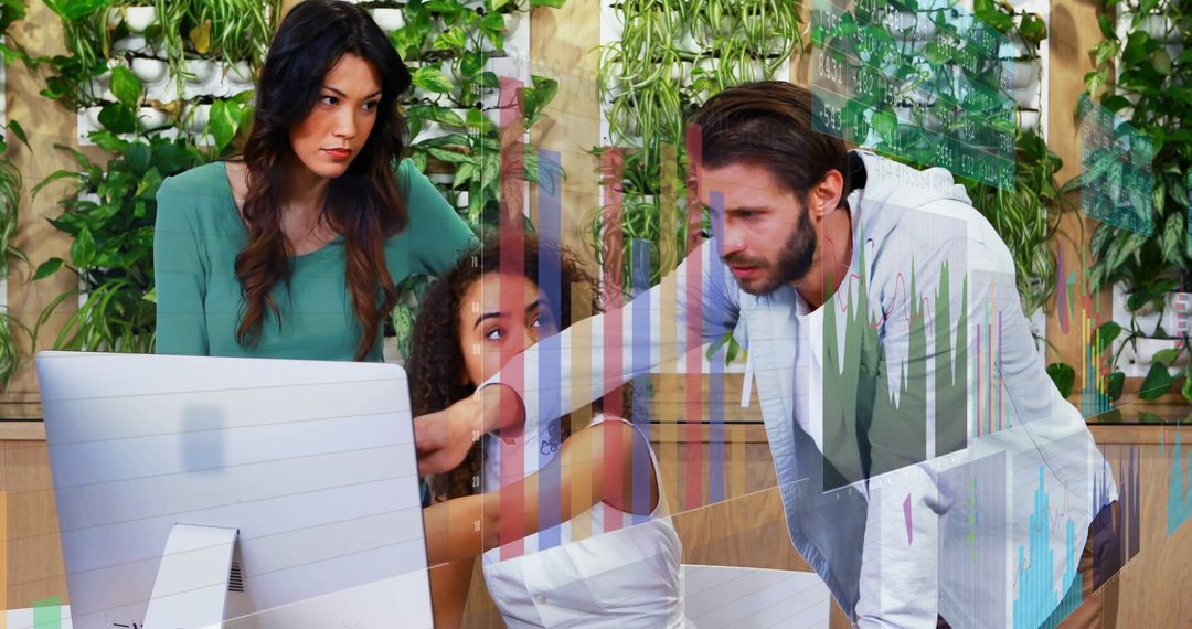 Team Analyzing Data Collaboratively on Office Monitor