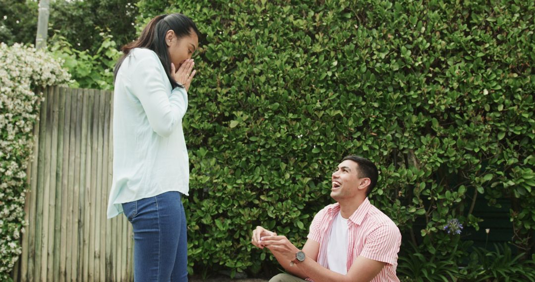 Man Proposing to Surprised Woman with Ring in Garden