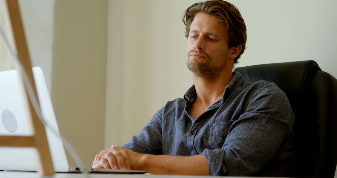 Thoughtful Professional Man Contemplating at Desk - Free Images, Stock Photos and Pictures on Pikwizard.com