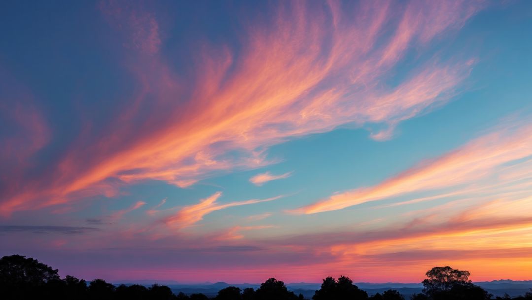 Pastel Clouds Stretching Across Serene Sunset Sky Over Treeline
