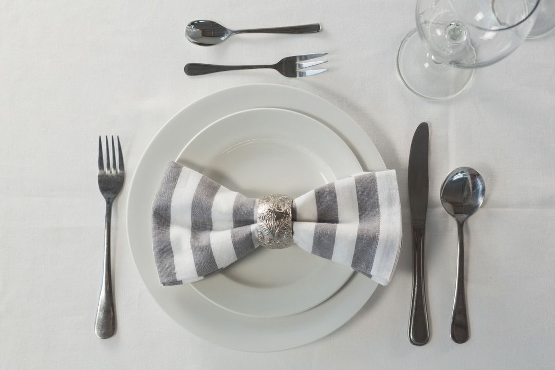 Elegant Table Setting with Striped Napkin and Silverware - Free Images, Stock Photos and Pictures on Pikwizard.com