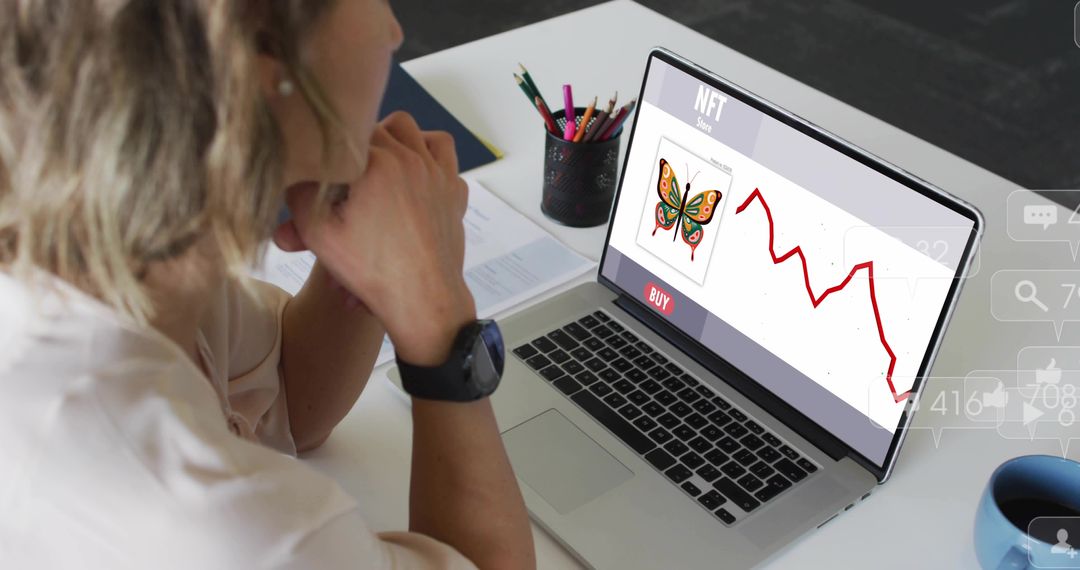 Woman viewing NFT marketplace on laptop with falling price chart, clasping chin at desk