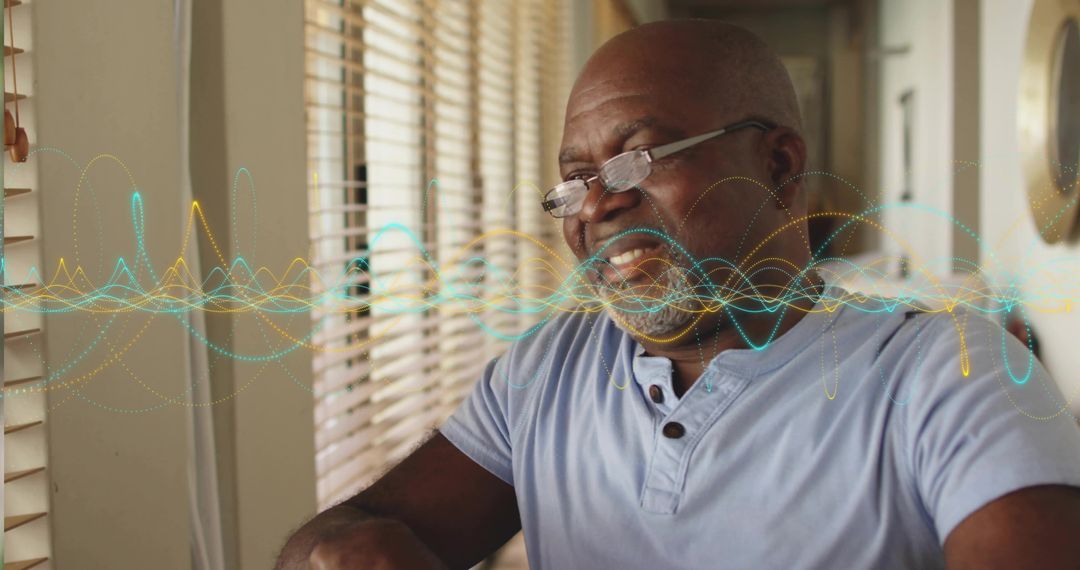 Elderly Man in Glasses Interacting with Audio Waveform at Home