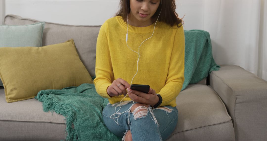 Young Woman Relaxing On Sofa And Using Smartphone With Earphones - Free Images, Stock Photos and Pictures on Pikwizard.com