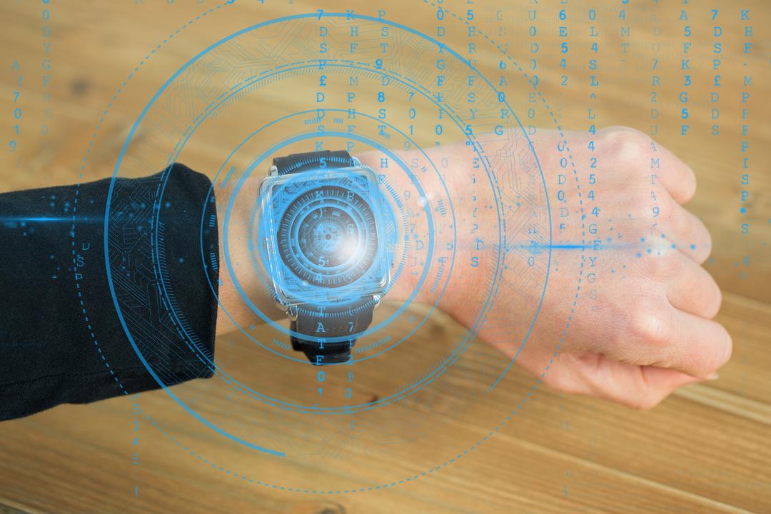 Hand Using Futuristic Smartwatch with Digital Graphics Overlay - Free Images, Stock Photos and Pictures on Pikwizard.com