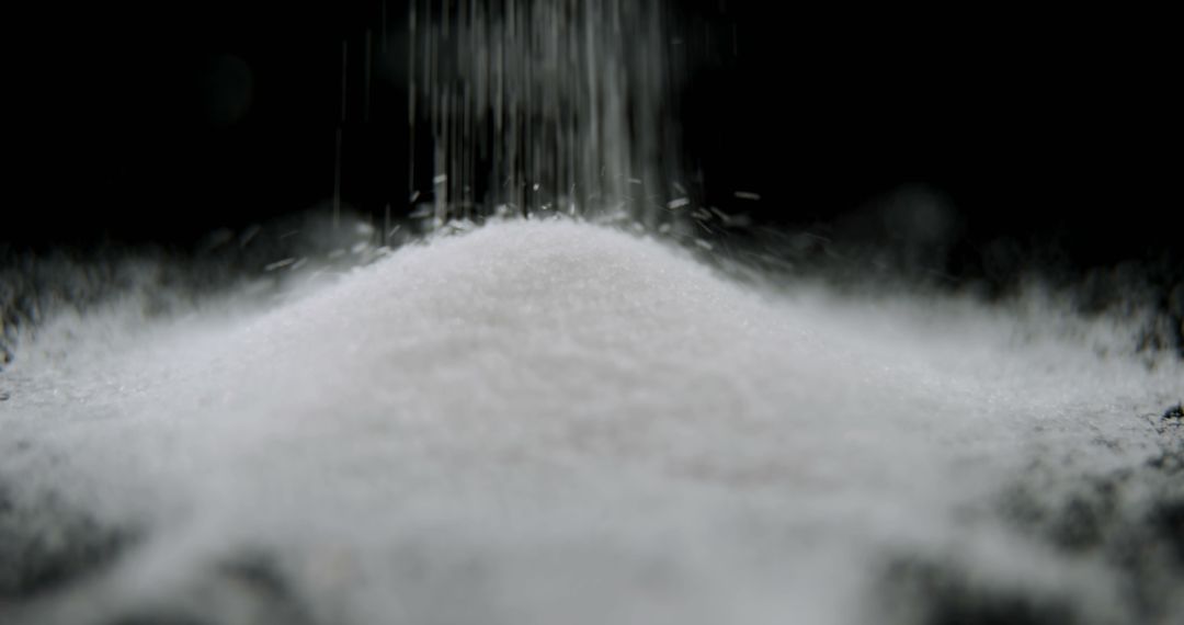 Fine white powder is being poured onto a mound against a dark background, with copy space - Free Images, Stock Photos and Pictures on Pikwizard.com