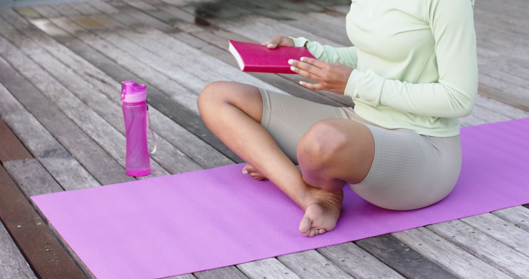 Woman Practicing Yoga and Reading Book on Wooden Deck - Free Images, Stock Photos and Pictures on Pikwizard.com