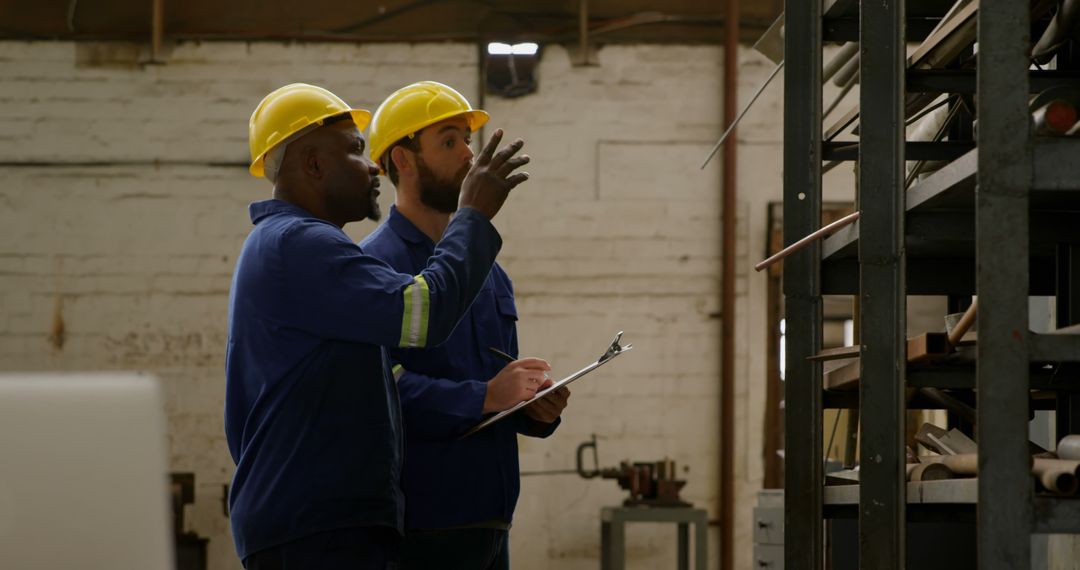 Industrial Workers Discussing Inventory in Warehouse - Free Images, Stock Photos and Pictures on Pikwizard.com