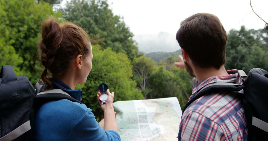Couple Navigating Forest Trails Using a Map