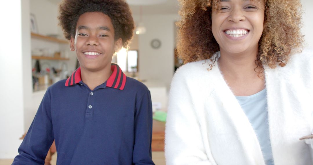 Mother and Son Smiling While Holding Recycling Boxes at Home
