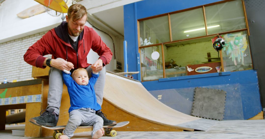 Father Teaching his Child Skateboarding in Indoor Skate Park - Free Images, Stock Photos and Pictures on Pikwizard.com