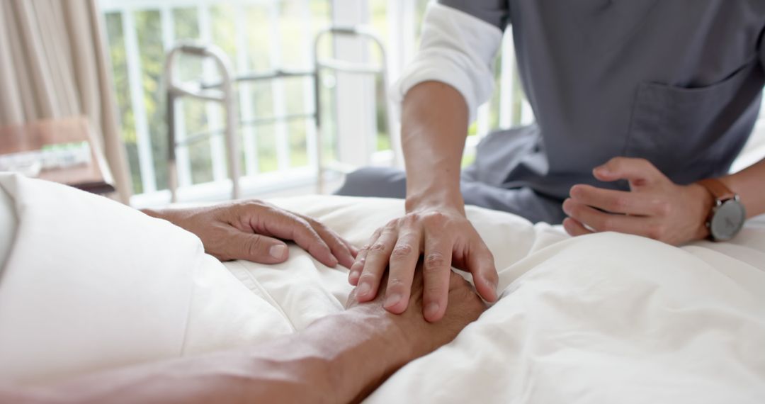 Nurse providing support and care to elderly patient in hospital bed - Free Images, Stock Photos and Pictures on Pikwizard.com