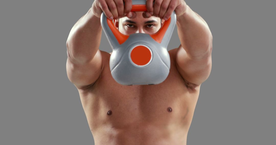 Muscular Man Lifting Kettlebell During Workout - Free Images, Stock Photos and Pictures on Pikwizard.com