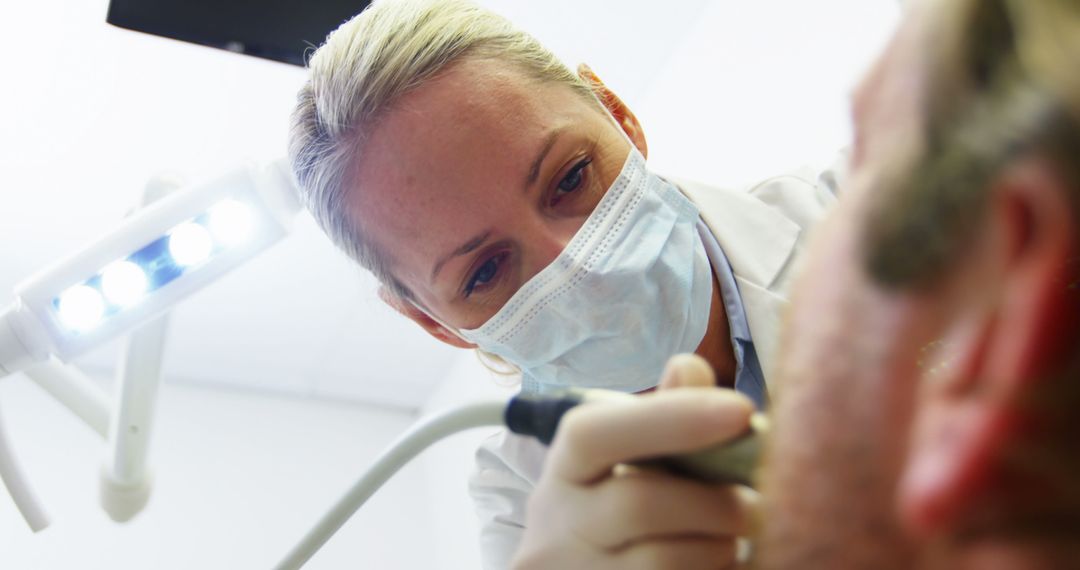 Female Dentist Examining Patient in Dental Office - Free Images, Stock Photos and Pictures on Pikwizard.com