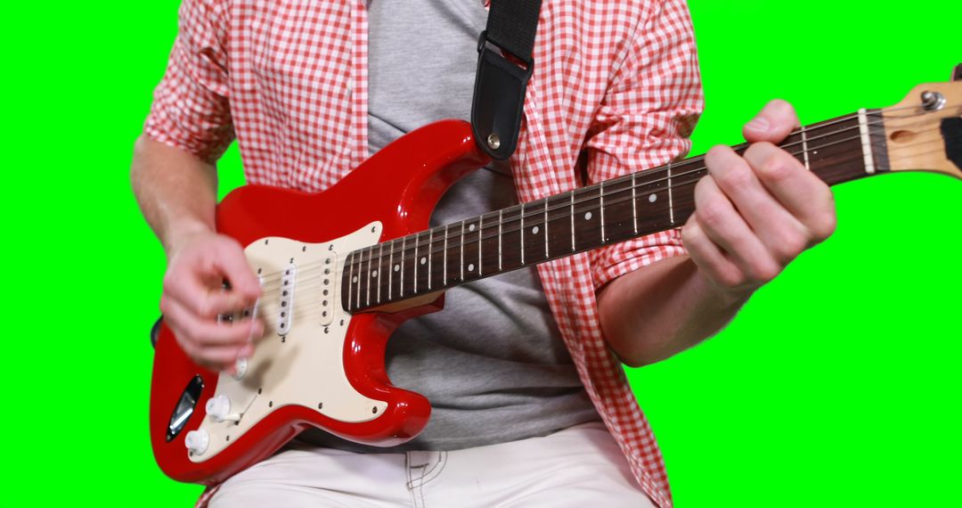 Man Playing Electric Guitar Against Green Screen - Free Images, Stock Photos and Pictures on Pikwizard.com