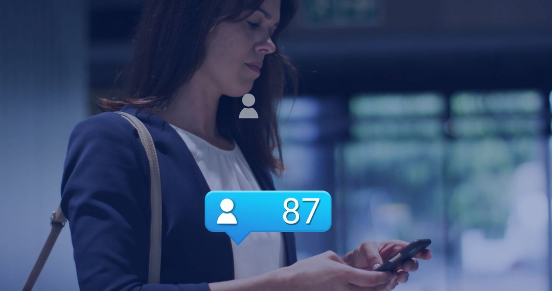 Businesswoman Engaging with Smartphone Notifications in Modern Lobby