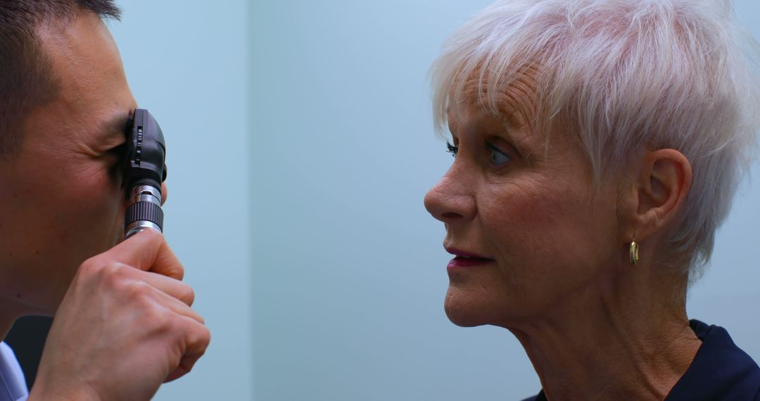 Doctor Examining Senior Woman Eye with Ophthalmoscope at Clinic - Free Images, Stock Photos and Pictures on Pikwizard.com