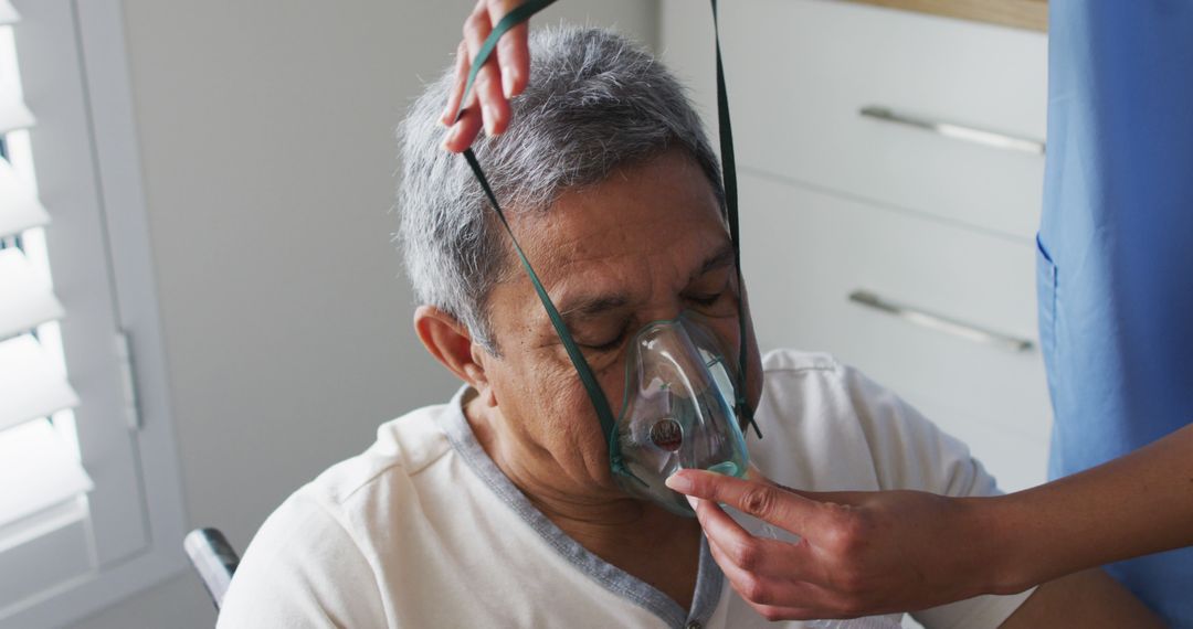 Elderly man in home receiving oxygen therapy from healthcare professional - Free Images, Stock Photos and Pictures on Pikwizard.com