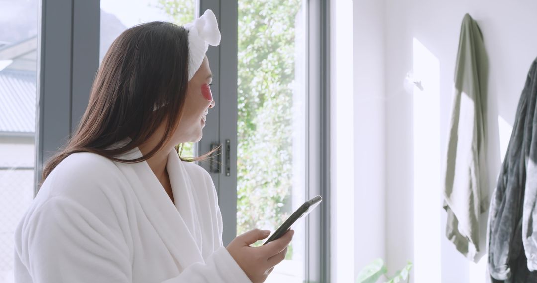 Woman Enjoying Skincare Routine by Sunlit Window
