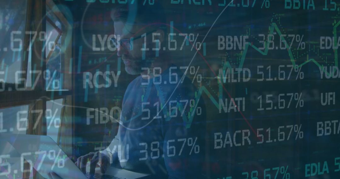 Stock Trader Analyzing Market Data on Laptop with Overlaid Figures - Free Images, Stock Photos and Pictures on Pikwizard.com