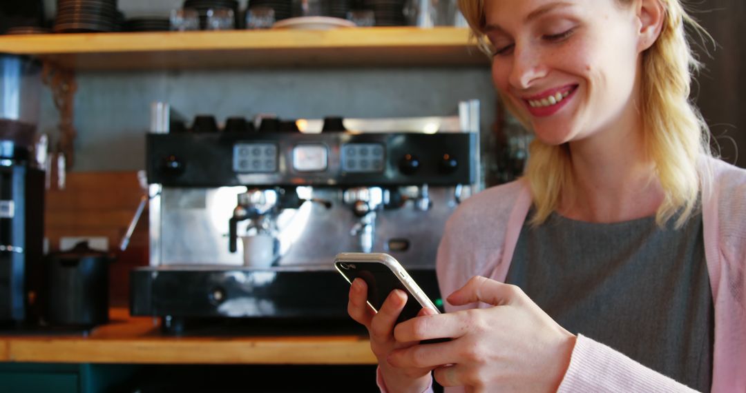 Smiling Barista Texting on Smartphone in Coffee Shop - Free Images, Stock Photos and Pictures on Pikwizard.com