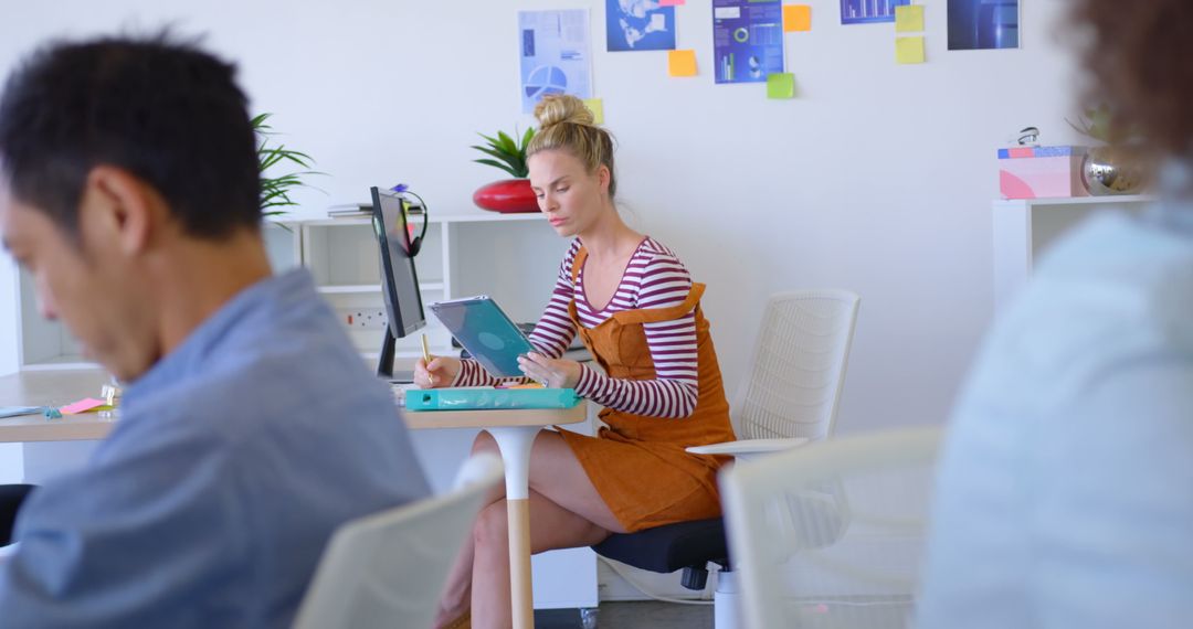 Focused young professional using digital tablet in modern office