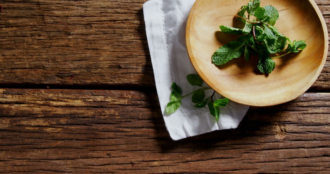 Fresh Mint Leaves in Wooden Bowl on Rustic Table - Free Images, Stock Photos and Pictures on Pikwizard.com