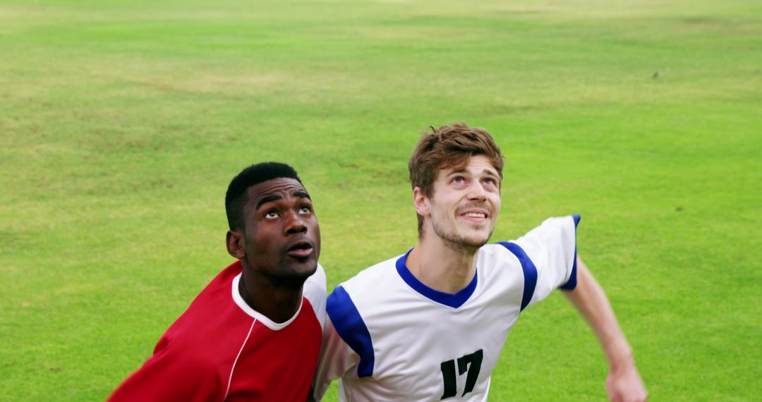 Two Soccer Players Watching Ball in Intense Soccer Game - Free Images, Stock Photos and Pictures on Pikwizard.com