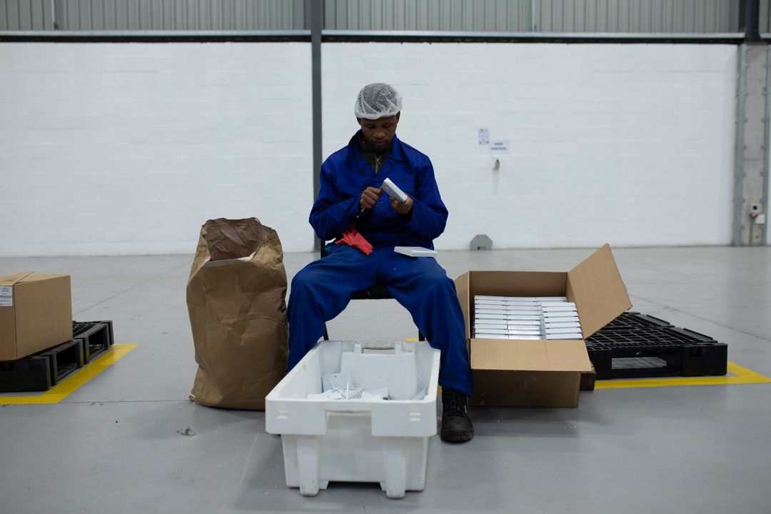 Front view of worker working in a factory - Free Images, Stock Photos and Pictures on Pikwizard.com