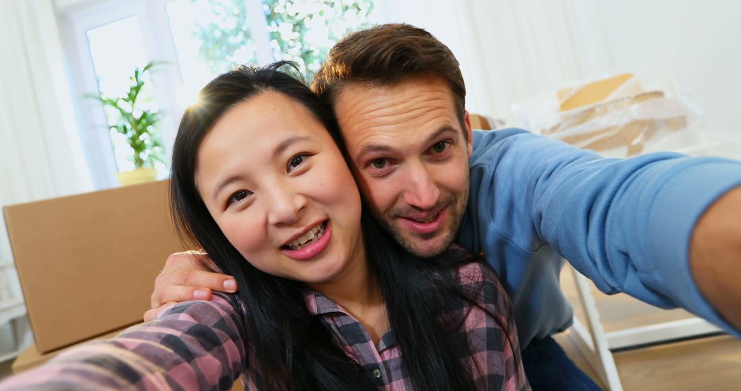 Happy Couple Taking Selfie During Moving Day at Home