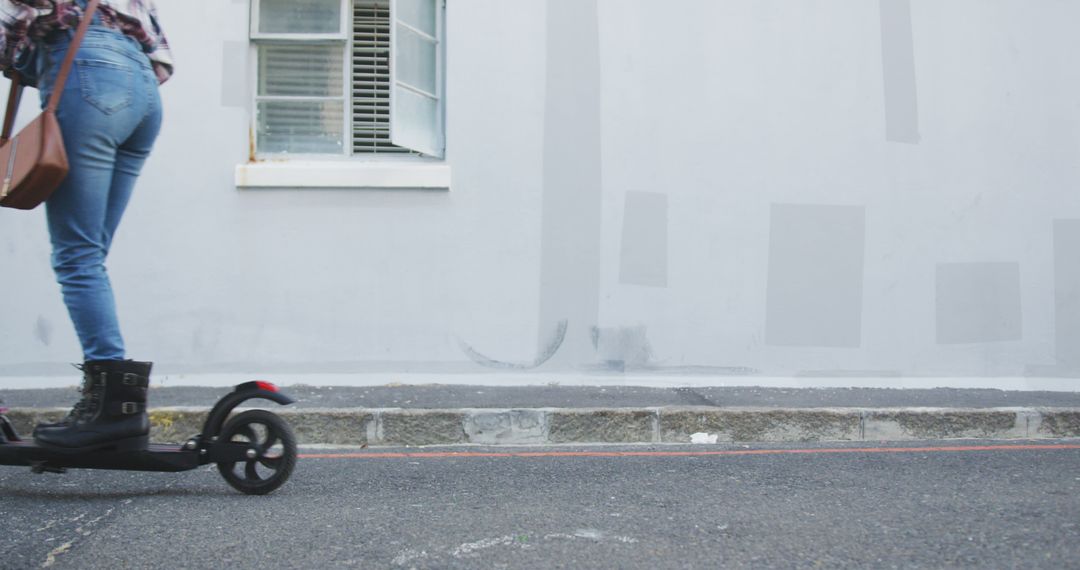 Woman Riding Electric Scooter on Urban Street with Minimalistic Background - Free Images, Stock Photos and Pictures on Pikwizard.com