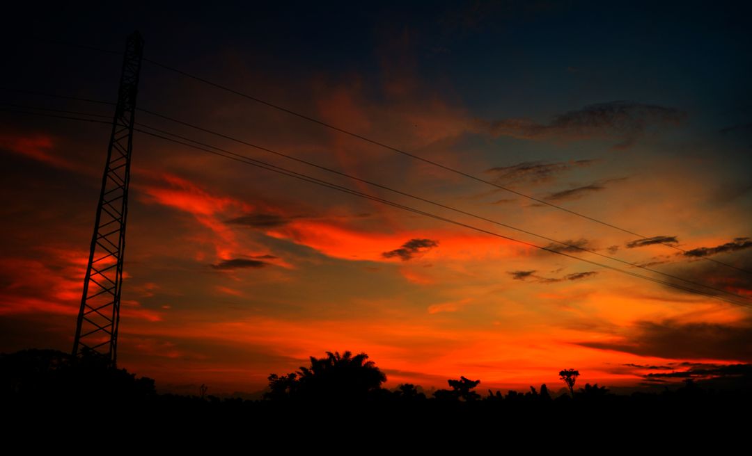 Dramatic Sunset Sky with Silhouetted Tall Structures and Trees - Free Images, Stock Photos and Pictures on Pikwizard.com