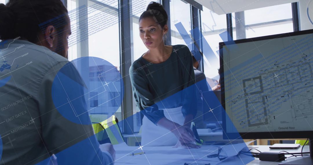 Architect Leading Team Pointing at Blueprints and Digital Floorplan on Monitor