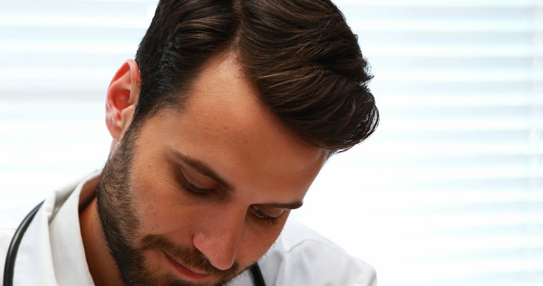 Young Male Doctor Concentrating on Work while Writing - Free Images, Stock Photos and Pictures on Pikwizard.com