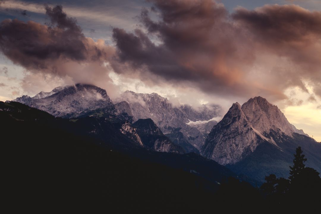 Dramatic Mountain Range at Sunset with Dark Clouds - Free Images, Stock Photos and Pictures on Pikwizard.com