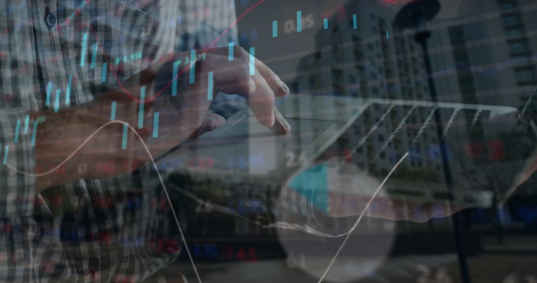Man Using Laptop with Financial Data Overlay