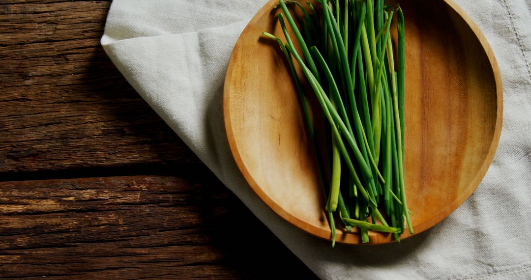 Fresh Green Chives on Wooden Plate on Rustic Table - Free Images, Stock Photos and Pictures on Pikwizard.com