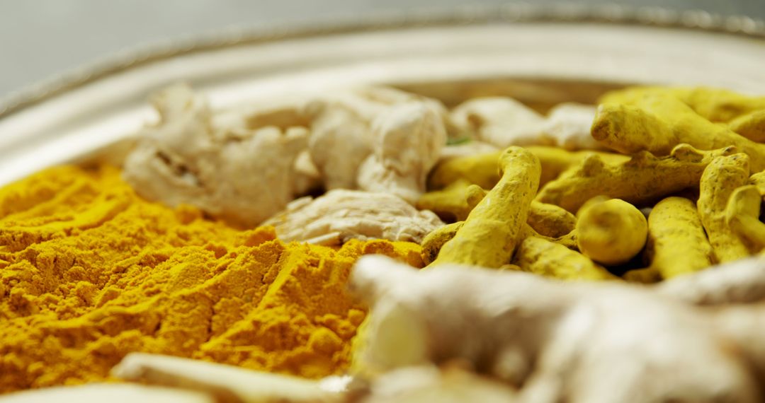 Close-Up of Turmeric Roots and Powder in Metallic Tray - Free Images, Stock Photos and Pictures on Pikwizard.com