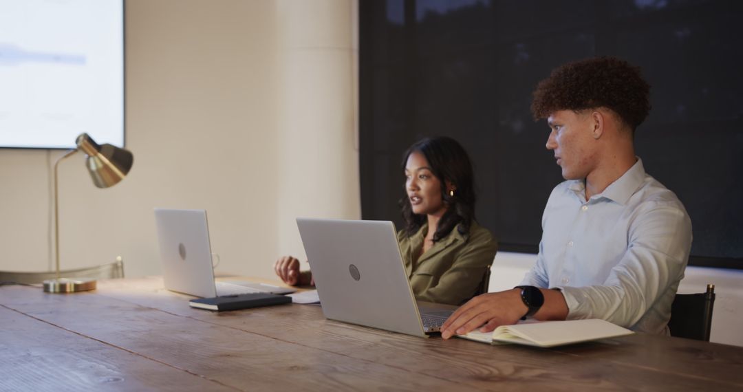 Young Professionals Collaborating on Project in Evening Office Meeting