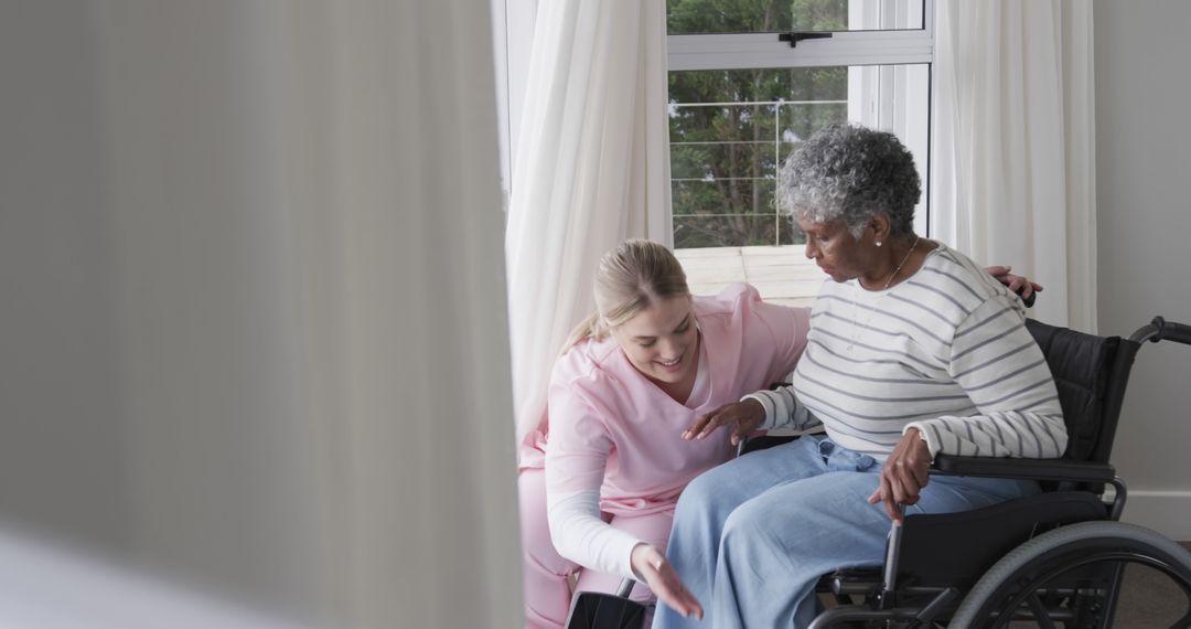 Nurse Assisting Elderly Patient in Wheelchair at Home - Free Images, Stock Photos and Pictures on Pikwizard.com