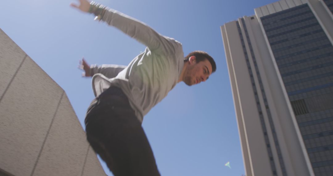 Young Man Parkour Jump Between Buildings in Urban Setting - Free Images, Stock Photos and Pictures on Pikwizard.com