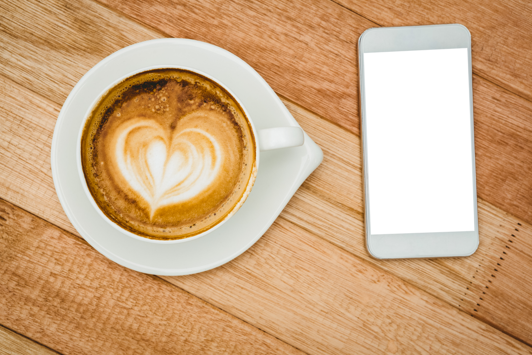 Transparent Smartphone and Cappuccino with Heart Latte Art on Table - Download Free Stock Images Pikwizard.com