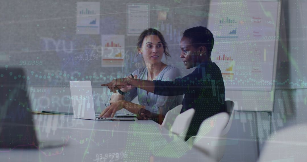 Diverse Female Coworkers Analyzing Financial Data Overlap on Screens