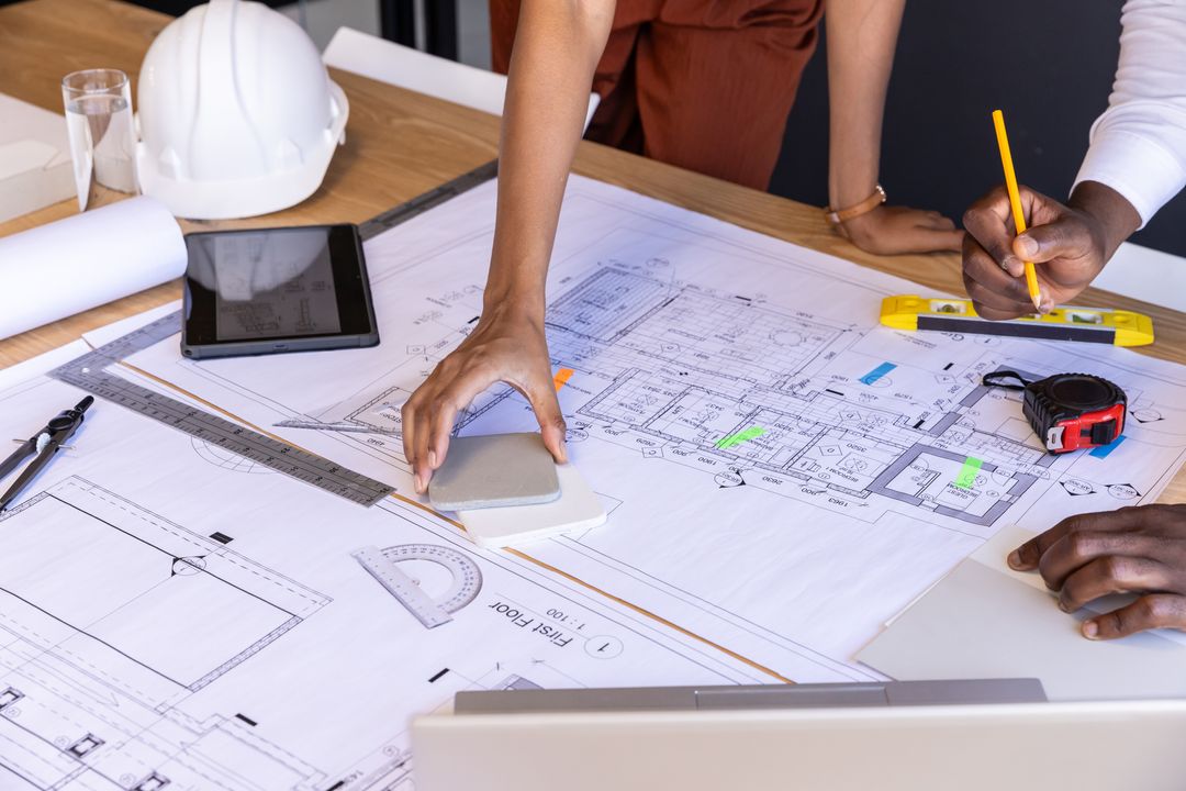 Architects Collaborating on Design Blueprint in Modern Office