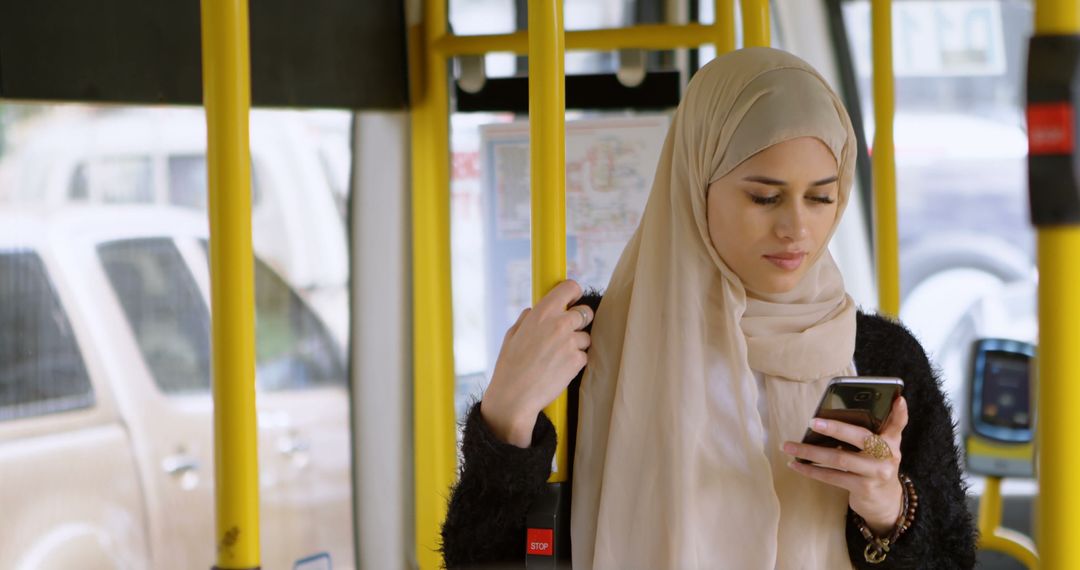 Muslim Woman Checking Smartphone While Riding Bus - Free Images, Stock Photos and Pictures on Pikwizard.com