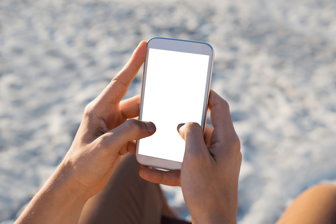 Transparent Smartphone Handheld by Hands on Beach
