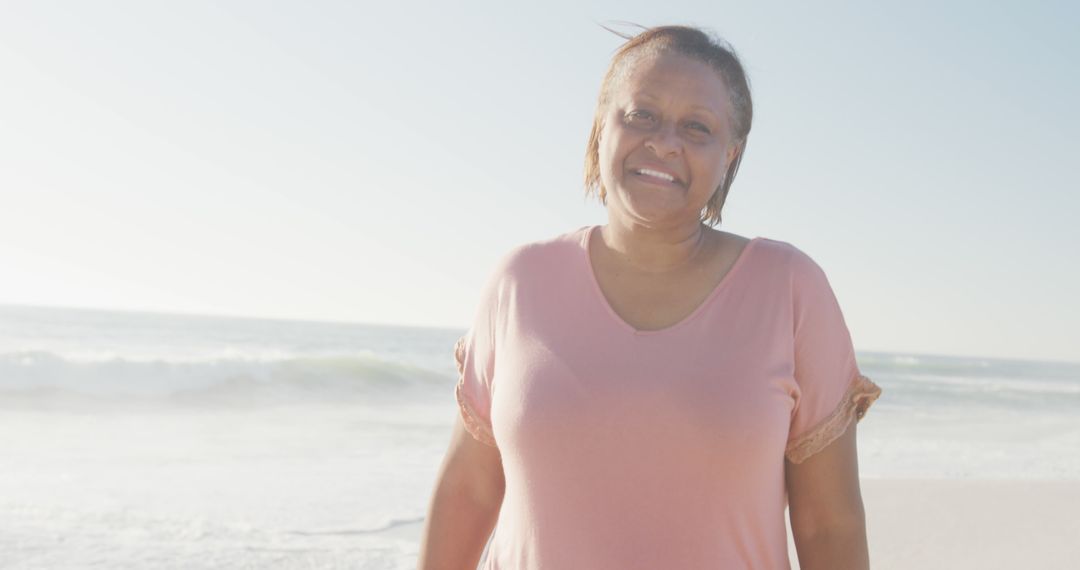 Smiling African American Woman Enjoying Beach Day - Free Images, Stock Photos and Pictures on Pikwizard.com