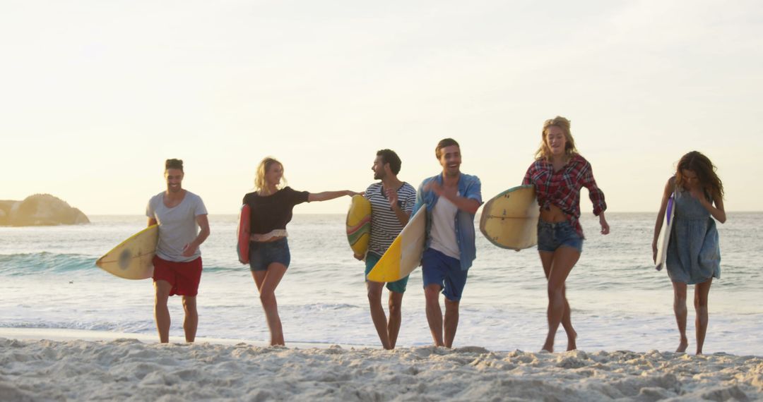 Group of Friends with Surfboards Enjoying Sunset on Beach - Free Images, Stock Photos and Pictures on Pikwizard.com