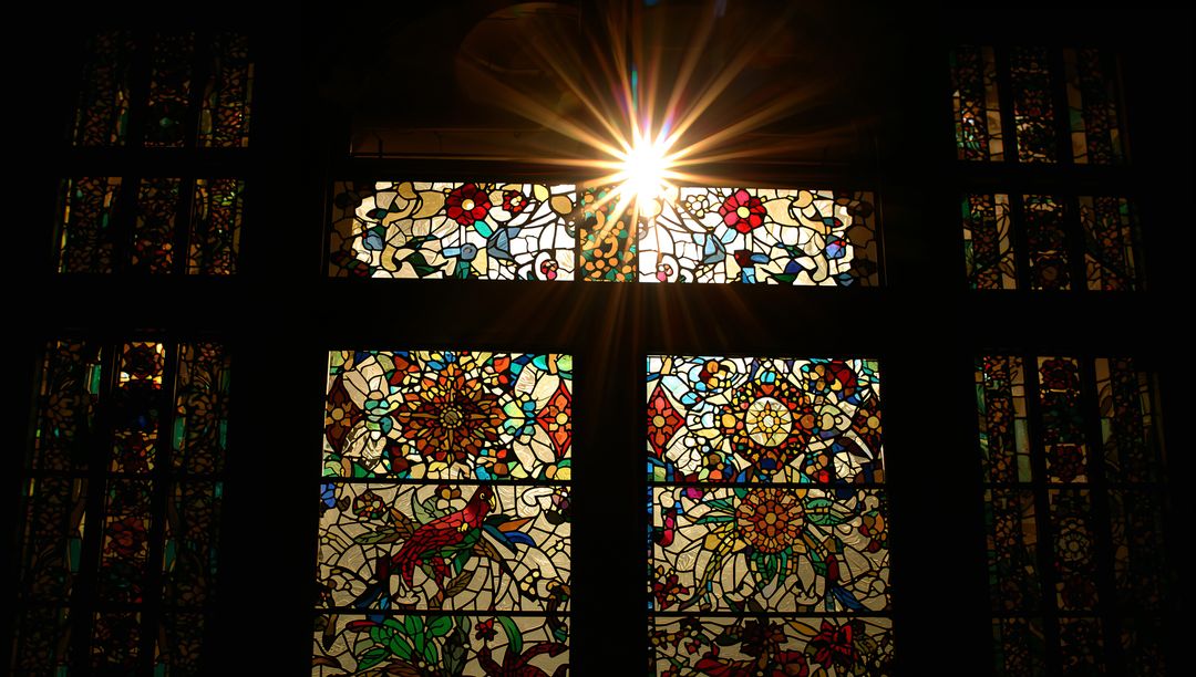 Sunburst Through Ornate Stained Glass in Chapel